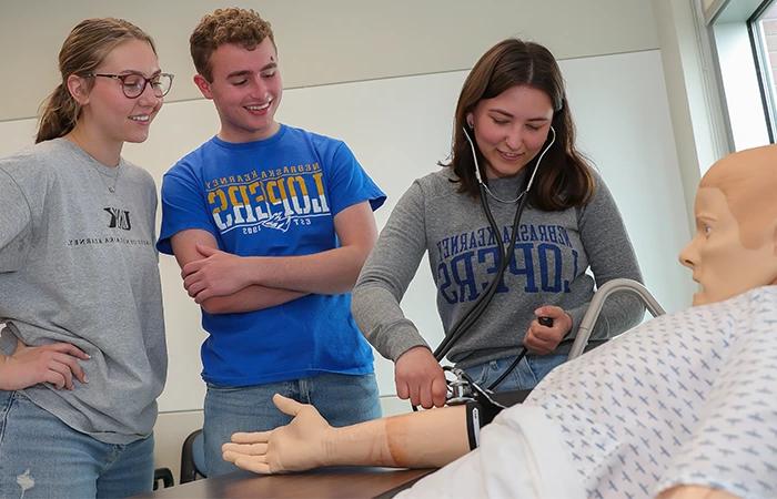 image of students practicing with a medical dummy